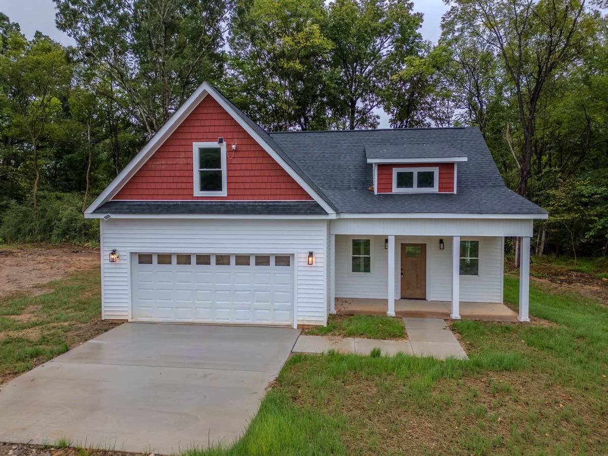 New home with a red gable and two car garage built by Suazo Contracting