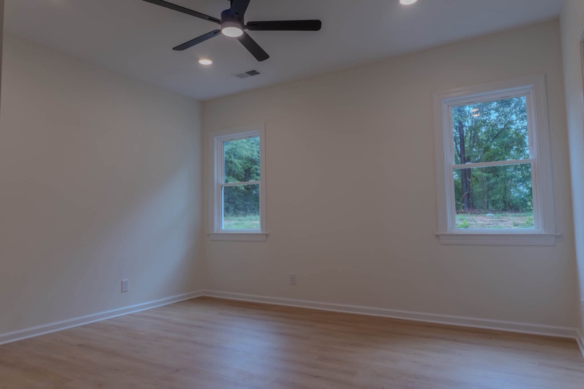 Finished room with a new ceiling fan and recessed lighting