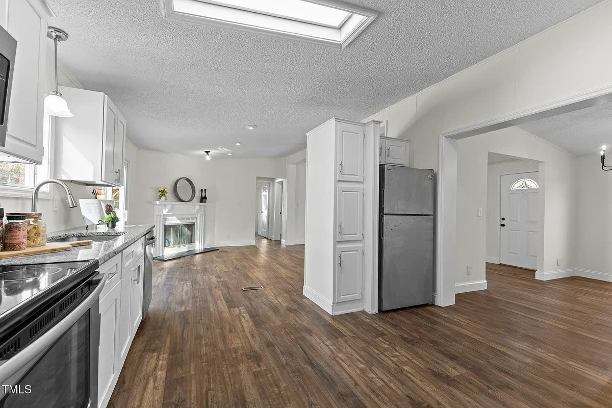 Bright kitchen and dining area with wood floors after a Suazo renovation