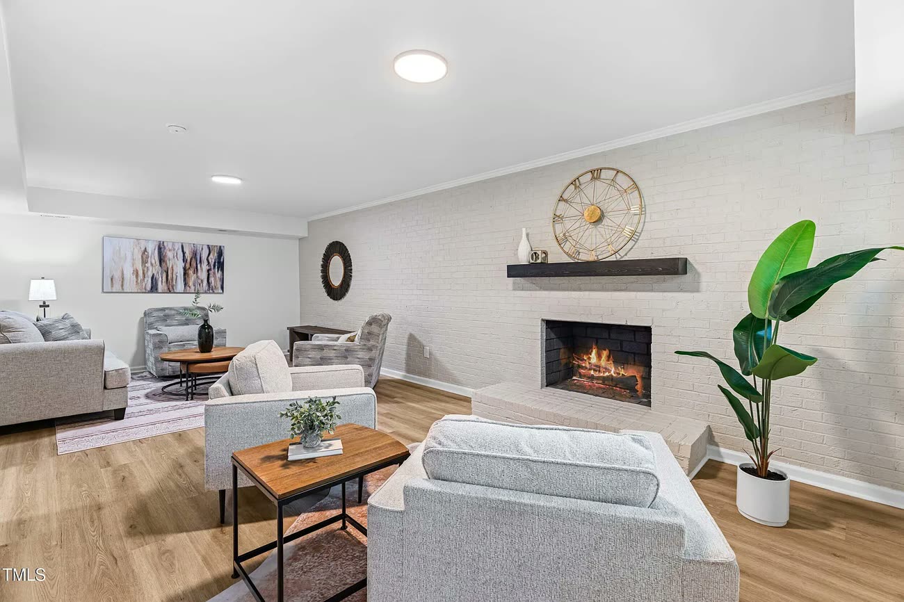 Living room with fireplace in a home cared for by Suazo Contracting